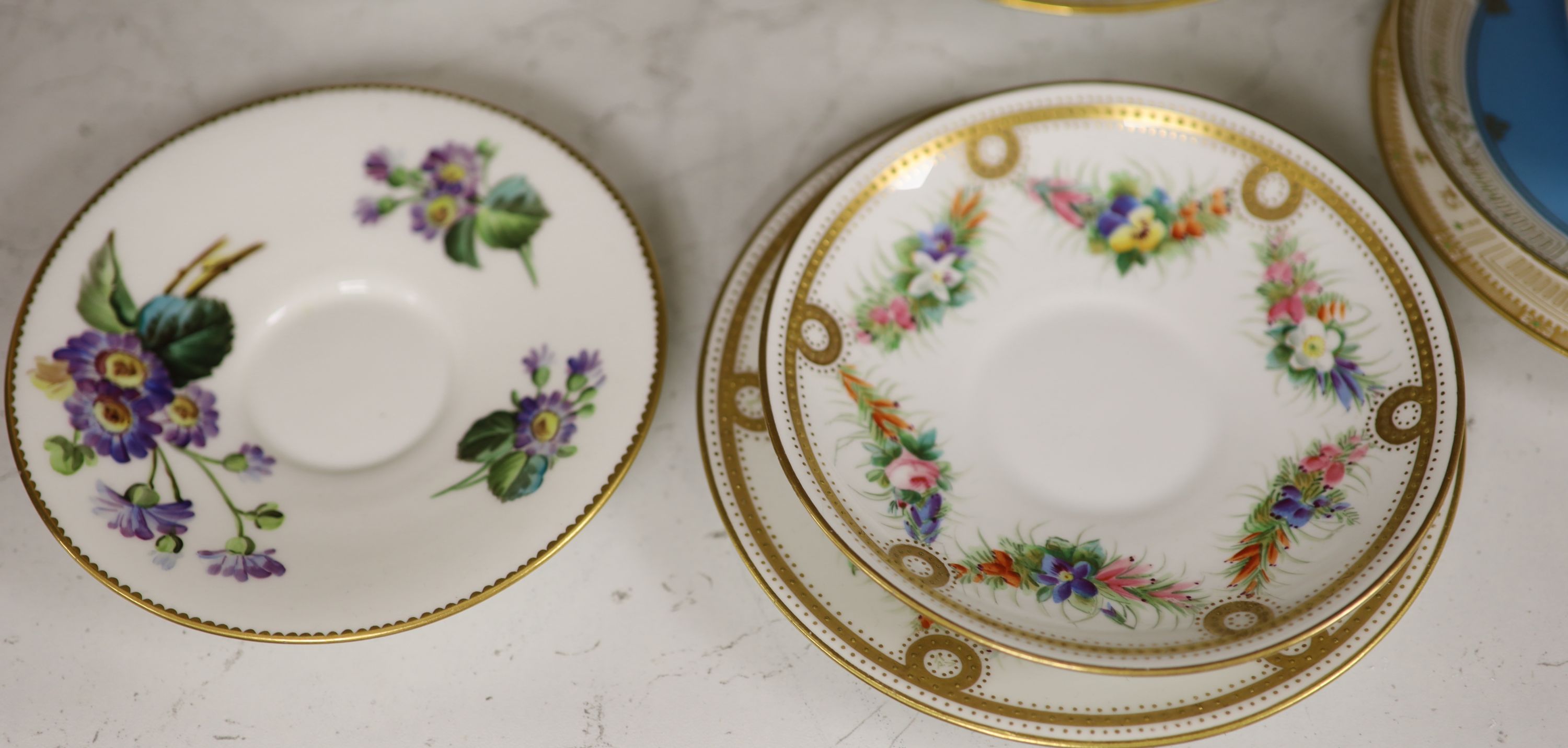 A Royal Worcester jewelled coffee cup and saucer painted with heathers by George Hundley, a Royal Worcester jewelled trio with gilt cla